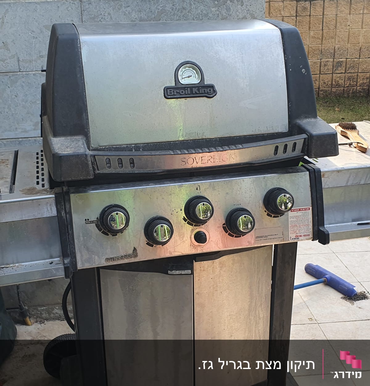 גריל גז עם כפתורים ומד חום בחצר